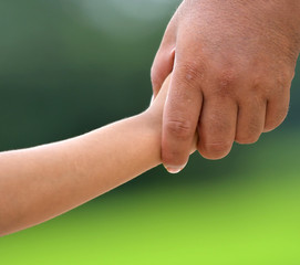 The hands of friendship between children and adults who hold hands together