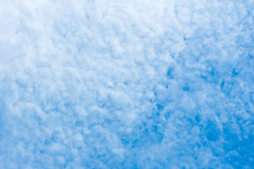 Fototapeta na wymiar white cirrocumulus clouds on blue sky