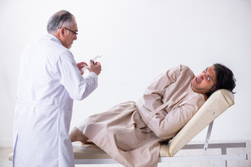 Aged male doctor psychiatrist examining young patient 