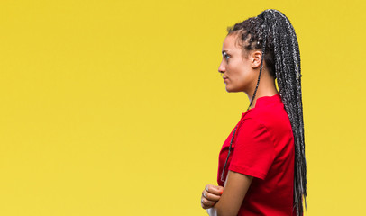 Young braided hair african american girl over isolated background looking to side, relax profile pose with natural face with confident smile.