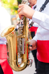 Street musicians plays his saxophone,playing the saxophone