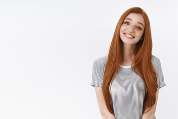Silly cute romantic young redhead girl blue eyes lovely smiling tilting head cute showing sympathy...