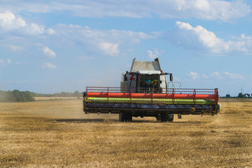Fototapeta na wymiar Harvesting wheat and barley modern combine.