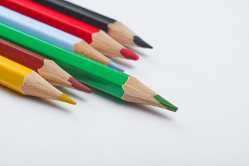 Set of colored pencils on a white background close-up