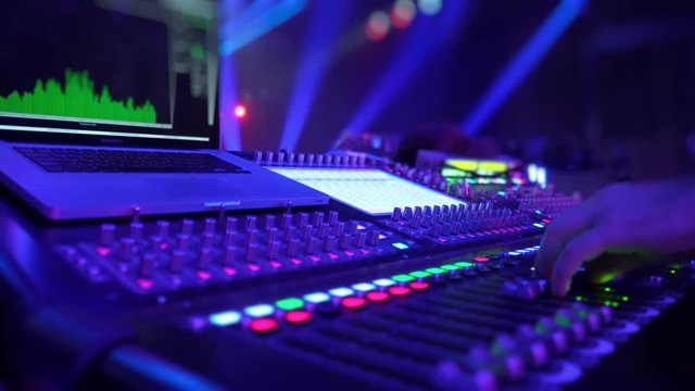 Remote control for adjusting the sound. Audio mixer. Sound engineer adjusts the sound. Music Festival. Change the volume level. Recording studio. Shooting a television show, a concert. Live broadcast.