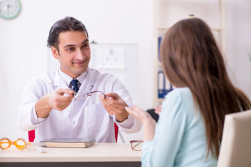 Young woman visiting male doctor oculist 