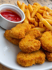 Fried chicken wings on wooden table. Breaded Crispy fried kentucky chicken tasty dinner with tomato sauce