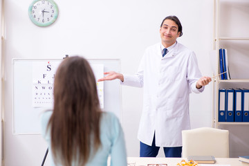 Young woman visiting male doctor oculist 