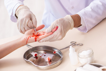 Hand injured woman visiting male doctor 
