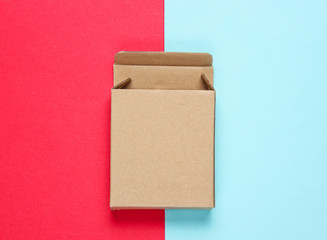Empty cardboard box on color paper background. Top view