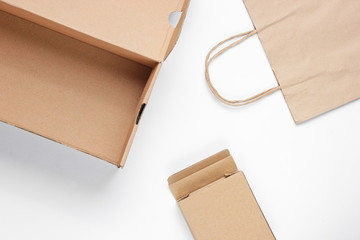 Eco concept. Cardboard boxes, paper bag on a white background. Top view