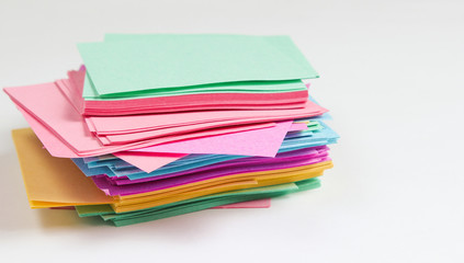Many colored memo sheets of paper on a white background