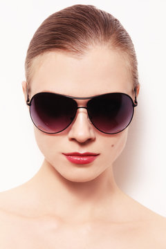 Portrait of young woman in vintage sunglasses