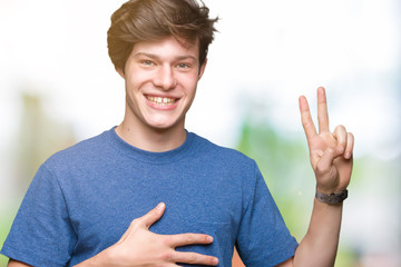 Young handsome man wearing blue t-shirt over isolated background Swearing with hand on chest and...