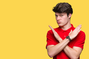 Young handsome man wearing red t-shirt over isolated background Rejection expression crossing arms doing negative sign, angry face