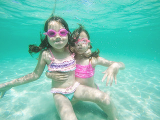 Obraz na płótnie Canvas Happy children underwater portrait swimming and dive in the sea