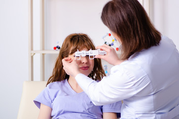 Young woman visiting female doctor oculist