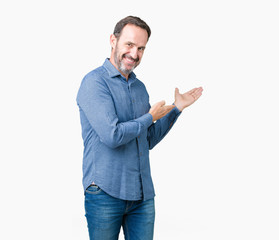 Handsome middle age elegant senior man over isolated background Inviting to enter smiling natural...