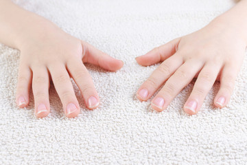 Naklejka premium child's hands with long nails, towel, closeup