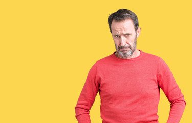 Handsome middle age hoary senior man wearing winter sweater over isolated background depressed and worry for distress, crying angry and afraid. Sad expression.