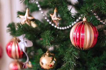 Fir tree branch with balls on a beautiful christmas background. Dressed christmas tree. New year concept