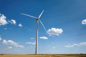 wind generator on bright cloudy sky background