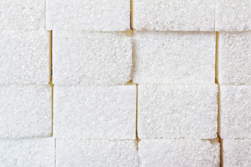 Sweet background from pieces of white sugar. Macro