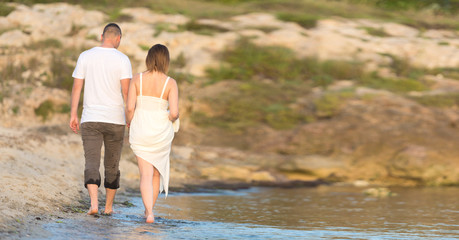 Happy Romantic Middle Aged Couple Enjoying Beautiful Sunset Walk on the Beach. Travel Vacation Retirement Lifestyle Concept