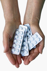 hand with pills isolated on white background