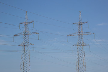 Electricity pylon on nature background . Electricity transmission power lines High voltage tower . Power line high voltage post with blue sky background.