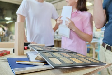 Group of people designer, client, carpenter, engineer choosing wooden products