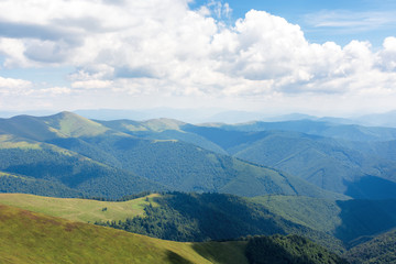 carpathian mountain summer adventure. grassy slopes and hills beneath a blue sky with fluffy clouds. wonderful sunny weather. great travel mood. location borzhava ridge, transcarpathia, ukraine