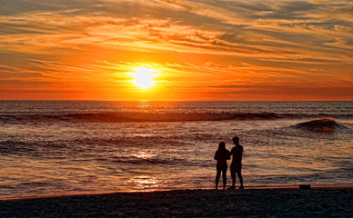 Couple on a California beach at sunset