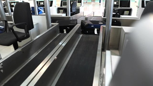 Luggage check-in at the airport.  Label being printed out at the check-in counter.