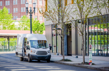 Compact cargo mini van loading cargo from multilevels building in the city down town © vit