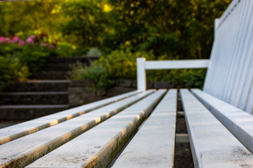white dirty park bench, close up and diminishing perspective