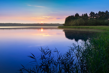 Sunrise over  Szarek Lake. Masuria. Poland.