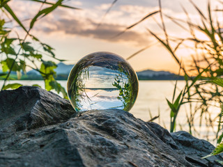 Sunset on the lake with a glass ball