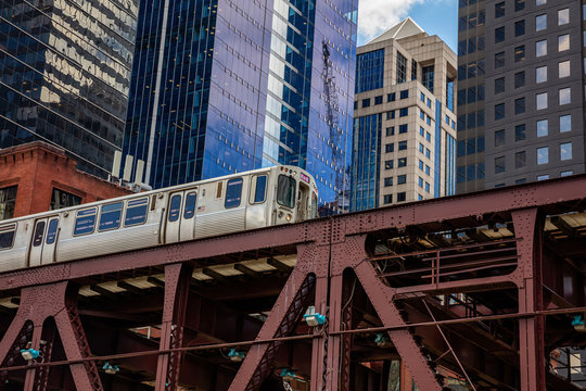 Chicago train on a bridge, skyscrapers background, low angle view