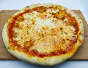 Pizza Margherita, traditional italian pizza, on wooden table 