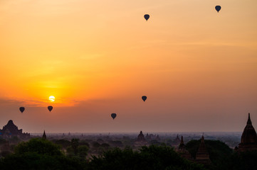 temples and many hot air balloons in bagan myanmar during sunrise
