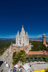 Barcelona, Spain - April, 2019: Tibidabo Cathedral. Temple of the Sacred Heart of Jesus at Mount Tibidabo. Barcelona, Spain. Blue sky with cloud of spring day. Famous landmark in Catalonia.