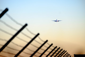 An airplane taking off and flying into the distant. Concept image of plane leaving.