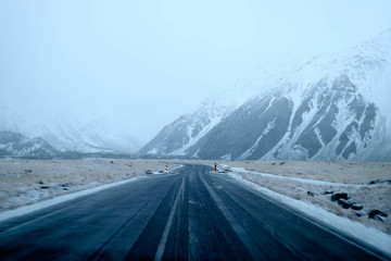 A straight road leading into the fog. Dangerous road condition. Low visibility driving. Winter...