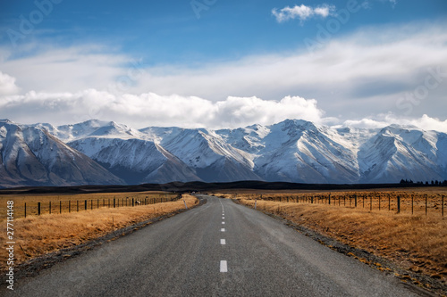 A Long Straight Road Leading Towards A Snow Capped Mountain In New Zealand Wall Mural Skyimages