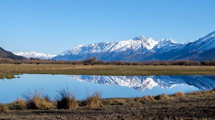 Natural peaceful image of New Zealand snow mountain. Idyllic image of mirror reflection lake.