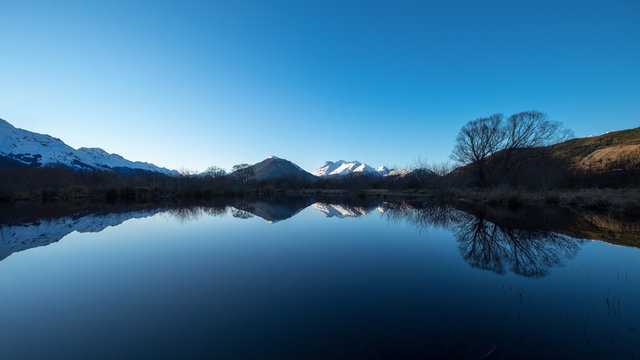 Natural peaceful image of New Zealand snow mountain. Idyllic image of mirror reflection lake.