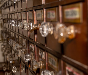 Old store with wooden drawers and glass handles and labels