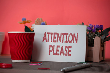 Writing note showing Attention Please. Business concept for Asking showing to focus their mental powers on you Flowers and writing equipments sheet above textured backdrop