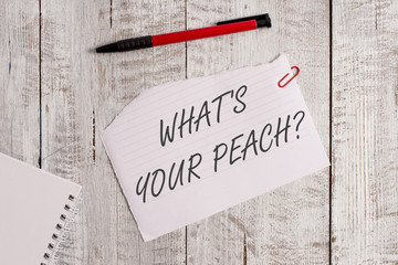 Word writing text What S Is Your Peach question. Business photo showcasing an exceptionally good demonstrating or thing Torn paper and notebook sheet with a pen placed on top of wooden table